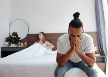 Couple experiencing emotional distance in bedroom, highlighting need for marriage counseling for sexless marriage
